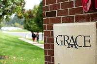 Students Walking Past Grace OCC Sign